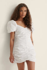 THE GATHERED RUSHED MINI ORGANIC COTTON DRESS - WHITE - EXCLUSIVE Dresses from NA-KD - Just $49.00! SHOP NOW AT IAMINHATELOVE BOTH IN STORE FOR CYPRUS AND ONLINE WORLDWIDE
